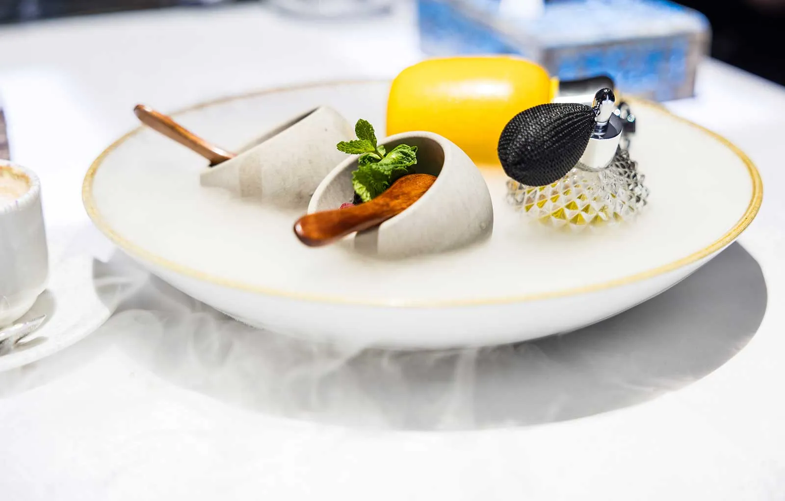 Fine-dining course served on a smoking plate