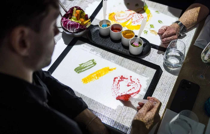 A guest painting with edible colours at the table