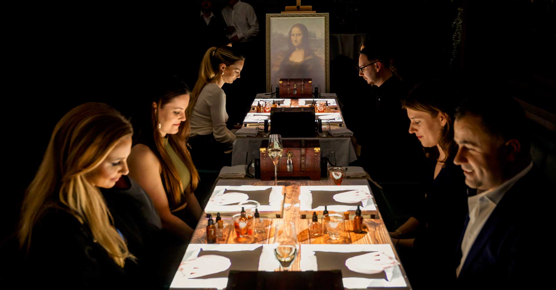 Guests dining beneath the Mona Lisa at the projection table